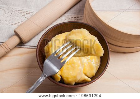 Close Up View Of Boiled Varenyky Or Dumpling With Cottage Cheese Or Curd On Metal Fork. Fresh Boiled