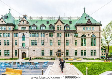 Quebec City Canada - May 29 2017: Old town street with Hotel de Ville City Hall park and people