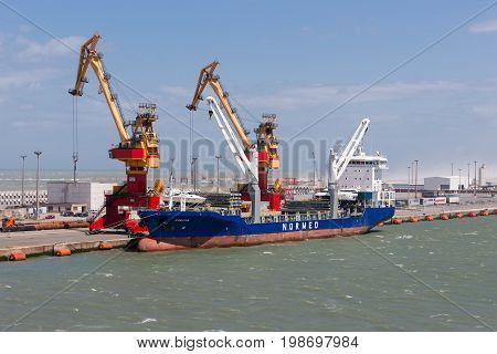 HARBOR CALAIS FRANCE - JUNE 07 2017: Carrier moored for loading and unloading in harbor of Calais France