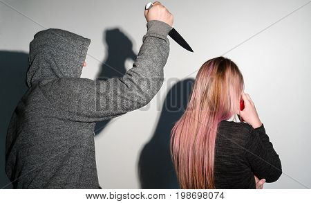 Robbery stalking a woman and holding a knife