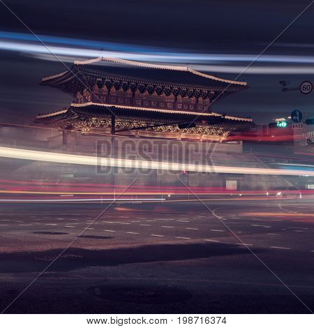 Seoul - July 2017: Dongdaemun Gate at night with light trails from traffic.