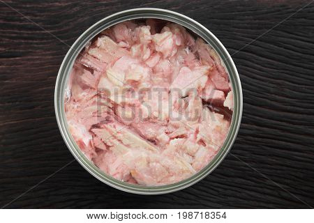 Canned soy free albacore white meat tuna packed in water on wood table background. Dark tone