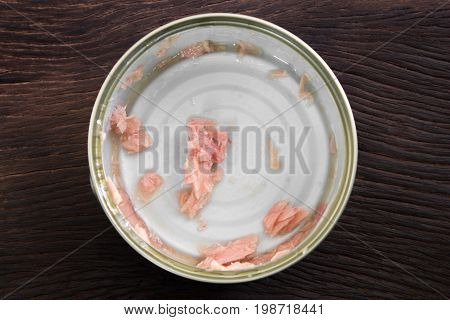 Canned soy free albacore white meat tuna packed in water on wood table background. Dark tone