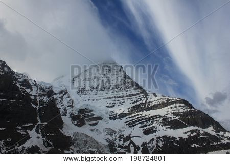 Mount Robson with streaks of clouds as a front moves through