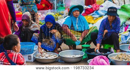 Koh Kong, Cambodia - January 3, 2017: Fish sellers (unidentified) on the central market of Koh Kong. Cambodian women in colorful clothes.