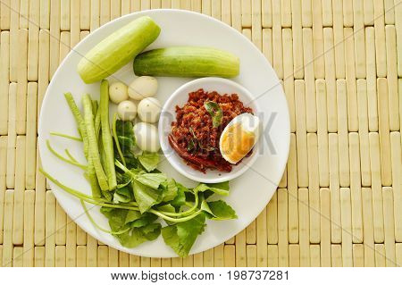 fried crispy catfish in chili paste sauce eat with salty egg and fresh vegetable