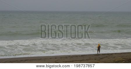 A lone fishermen in the surf at the beach
