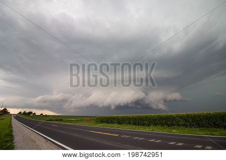 A wall cloud gathers under the base of a supercell thunderstorm in Iowa.