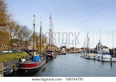 Boats and yachts in harbor of litlle historical city in Holland