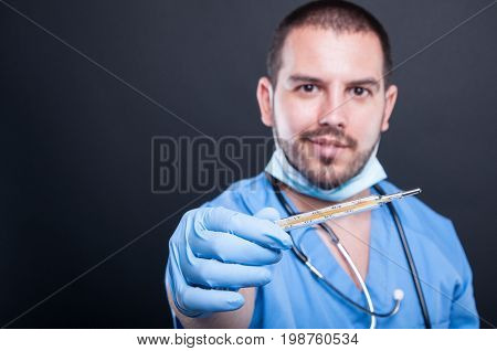 Selective Focus Of Doctor Wearing Scrubs Showing Thermometer