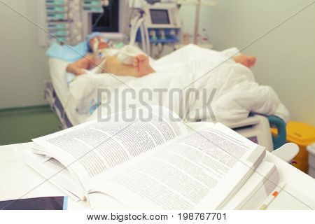 Reading book in the hospital ward. Medical study