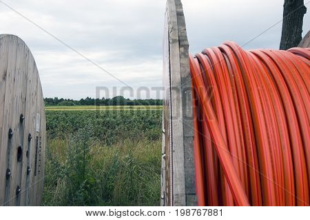 Laesoe Denmark - July 27 2017: Fiber optic cable for fast internet ready to dig down on Laesoe island in Kattegat Sea Denmark.Black currant field in the background.