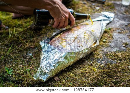 Preparing Big Dentex Fish For Barbecue Cooking On Picnic Outside.