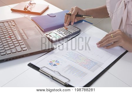Business person analyzing financial statistics graph on the paperwork