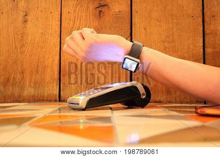 Contactless Payment Smartwatch Pdq With Hand Holding Credit Card To Pay