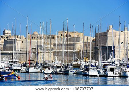 VITTORIOSA, MALTA - MARCH 31, 2017 - View of Senglea and Vittoriosa marina and waterfront buildings with views towards Fort St Angelo Vittoriosa (Birgu) Malta Europe, March 31, 2017.