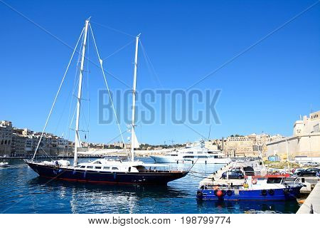VITTORIOSA, MALTA - MARCH 31, 2017 - View of yachts moored in the marina with views towards Senglea to the left Vittoriosa to the right and Valletta to the rear Vittoriosa Malta Europe, March 31, 2017.
