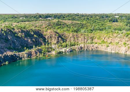 Ukraine Migea lake on the site of the former granite quarry. Steel cables trolley Zipline route over the lake. Zipline xtreme and active rest.