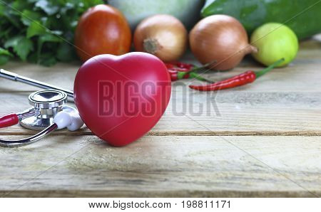 Healthy hearth concept vetgetable and fruit with herb leaf and ear doctor on wood background
