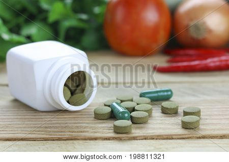 Healthy hearth concept Herbal Medicines with herb leaf and vetgetable on wood background