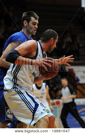 KAPOSVAR, HUNGARY - MARCH 31: Laszlo Orosz (in white) in action at a Hugarian Cup basketball game Kaposvar vs. Sopron March 31, 2010 in Kaposvar, Hungary.