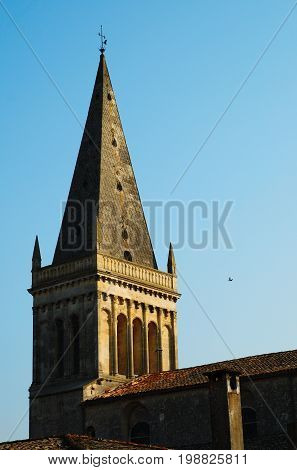 Pointy roof of a church on a cloud-free blue sky.
