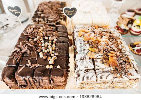 cake with hazelnut, pickle and raisin. Delicious wedding reception candy bar Dessert table for a wedding outdoor party