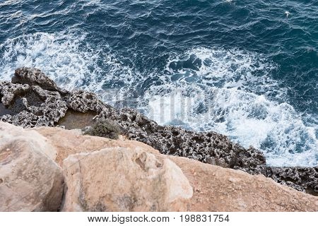 rocky coastal scenery at the Mediterranean Sea on Majorca in the back light