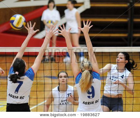 KAPOSVAR, HUNGARY - MARCH 21: Zsuzsanna Czmerk (4) strikes the ball at the Hungarian NB I. League woman volleyball game Kaposvar vs. Eger, March 21, 2010 in Kaposvar, Hungary.