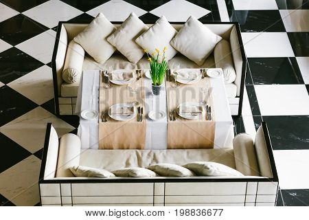 Stylish White Dining Table And Sofas. Minimalist Interior In Monochrome. Black And White Concept. Em