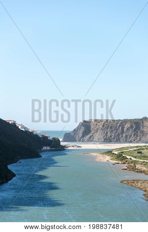 Beach in Alentejo Portugal, river meets the ocena