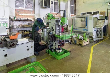 LIPETSK, RUSSIA - JUNE 15, 2017: Lipetsk Machine Tool Plant Workers are engaged in assembling and setting up a vertical milling machine.