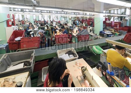 MOSCOW, RUSSIA - FEBRUARY 21, 2017: Moscow shoe factory JSC RALF RINGER . Female and male workers on a sewing machine.