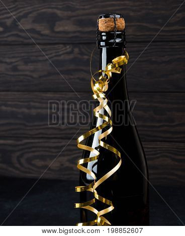 Wine Bottle On Wood Floor And Grunge Background, Nearby Cork, Tinsel, The Concept Of The Celebration