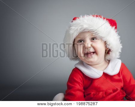 portrait of cute female caucasian child with santa claus clothes