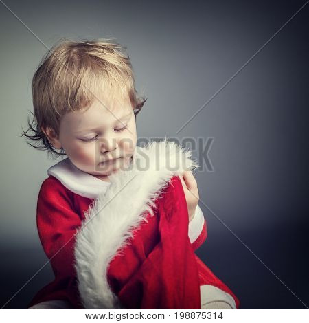portrait of cute female caucasian child with santa claus clothes