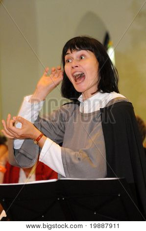 KAPOSVAR, HUNGARY - AUGUST 26: Kardi Hunt conducts at the IV. Pannonia Cantat Youth Choir Festival August 26, 2010 in Kaposvar, Hungary