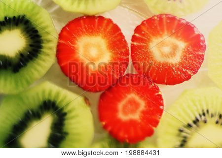 strawberry and kiwi cut circles background close up photo