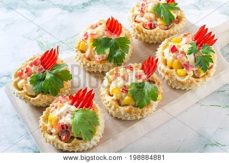 Vol-au-vent filled with chicken salad sweet pepper egg and corn. Festive appetizer for Christmas Valentine's Day Easter. Colorful snack of French cuisine from air puff pastry with filling