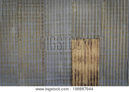 Heavily rusted exterior siding along a building