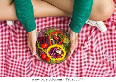 Close-up Of Pretty Girl Hands Holding Fresh Mixed Colorful Fresh Vegetable Salad In Glass Bowl. Vege