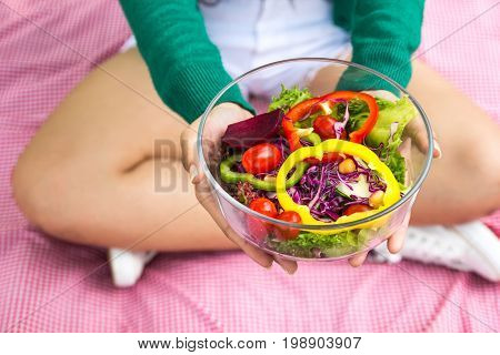 Close-up Of Pretty Girl Hands Holding Fresh Mixed Colorful Fresh Vegetable Salad In Glass Bowl. Vege