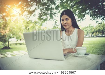 Young Girl Using Laptop Computer Outdoors. Beautiful Woman Working With Notebook. Student Working On