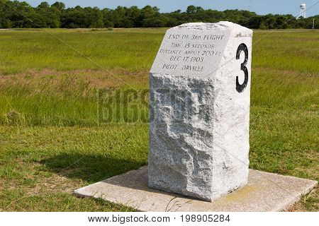 KILL DEVIL HILLS, NORTH CAROLINA - JULY 14, 2017:  Stone marker indicating the landing site of the third successful flight by Wilbur and Orville Wright at the Wright Brothers National Memorial.