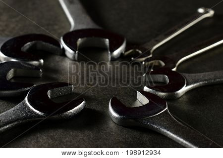 Open ended spanners on black surface. Horizontal image.