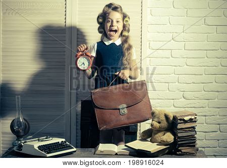 Small Girl With Curler In Hair With Typewriter.