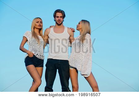 Girl and women with boyfriend outdoor. Blonde and guy with athletic chest. Love and romance. Beauty and fashion. Man with muscular body with twins.