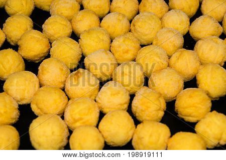 Baking tray with deep-frozen round potato croquettes made from fresh mashed potatoes.