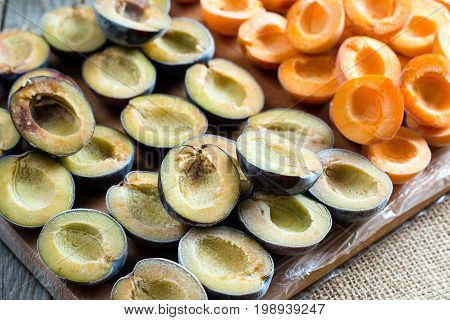 Frozen apricots and plums on a cutting board