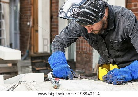 Man Makes A Metal Construction